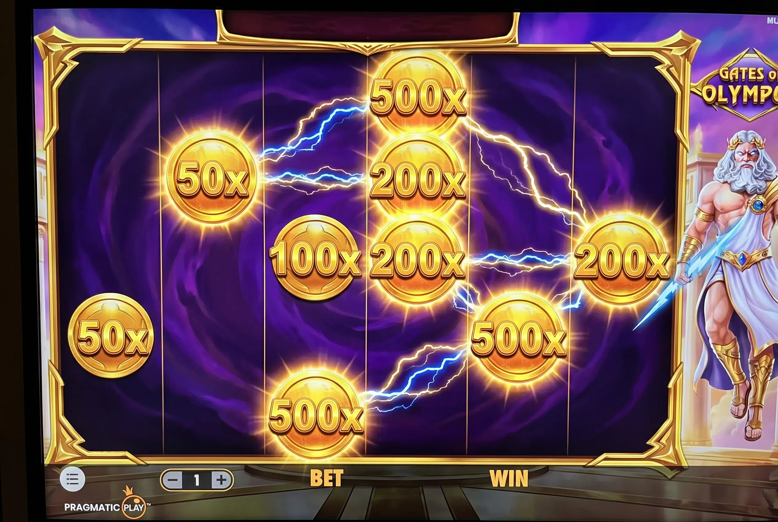 Gates of Olympus multiplier coins - 50x, 100x, 200x, 500x golden coins on the grid